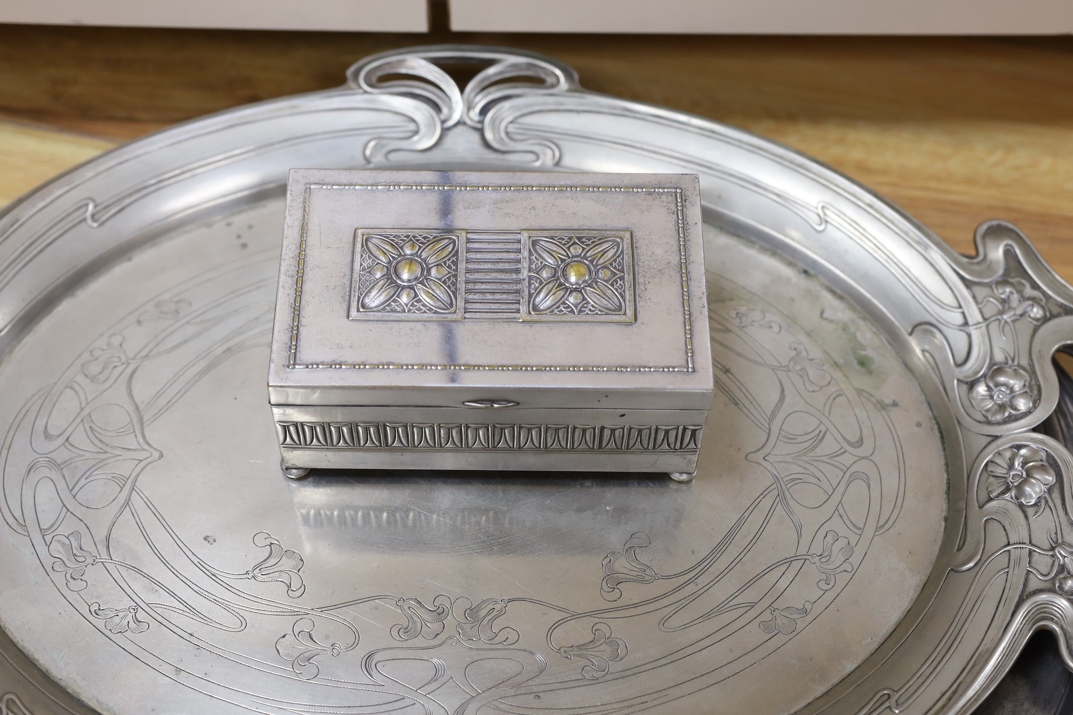 An Edwardian oval Art Nouveau metal tray, a similar oak and pewter tray and a WMF box, pewter tray 58 cms wide.